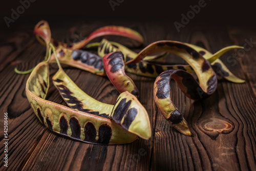 Acacia seeds. black locust. whte acacia on wooden background photo