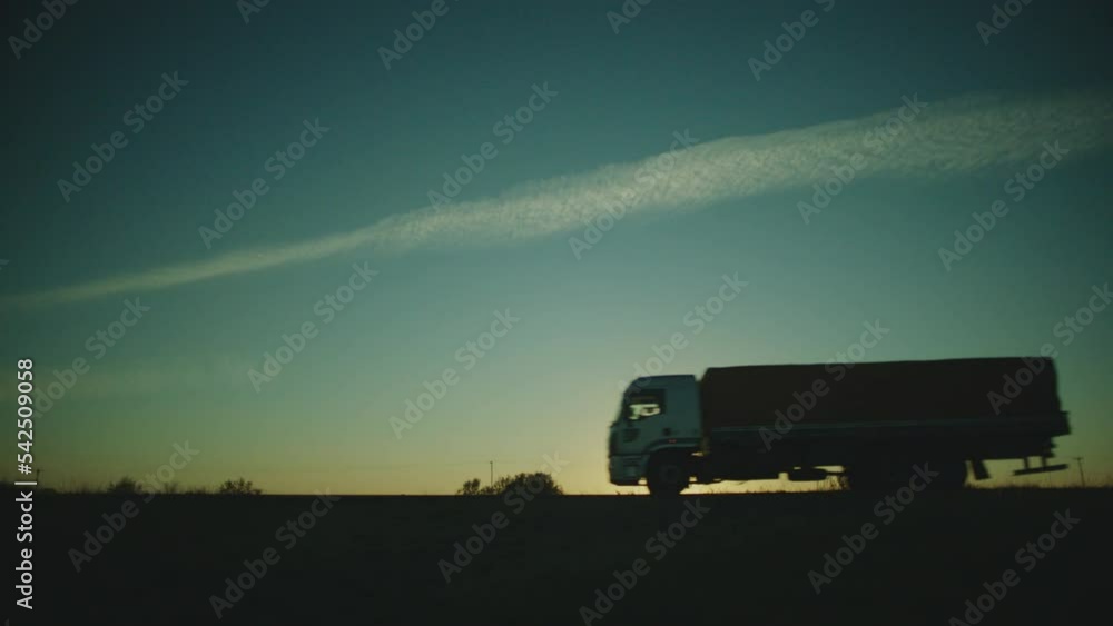 establishing side shot of the road with a truck and a car passing by at brazil