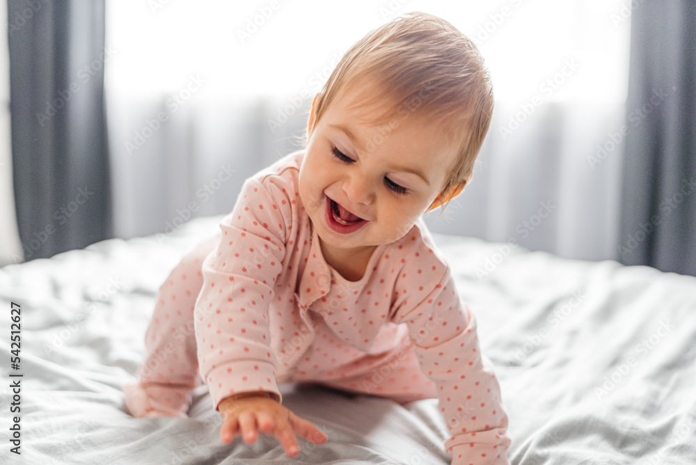 Portrait of a crawling baby on a bed in her room Portrait of a crawling baby on a bed in her room