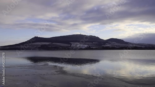 Time lapse of a beautiful winter landscape at sunset. View of Lake Musov and the top of Palava. Devicky Castle can be seen. In the background are dramatic clouds.