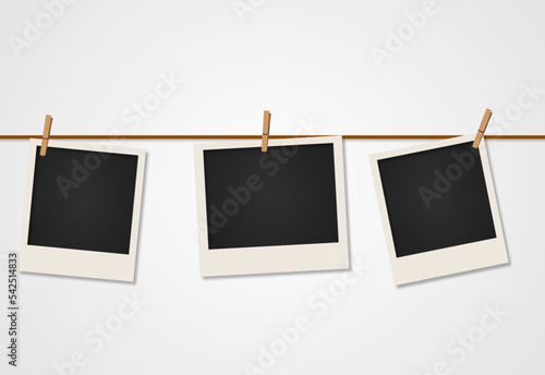 blank photo frames on rope, frames on wooden background, Realistic polaroid photo template. Empty photo frame mock up with shadow. Vintage card. Vector illustration on transparent background.
