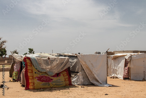 Refugee camp in Africa, full of people who took refuge due to insecurity and armed conflict. People living in very poor conditions, lack of food, clean water and proper shelter to stay  photo
