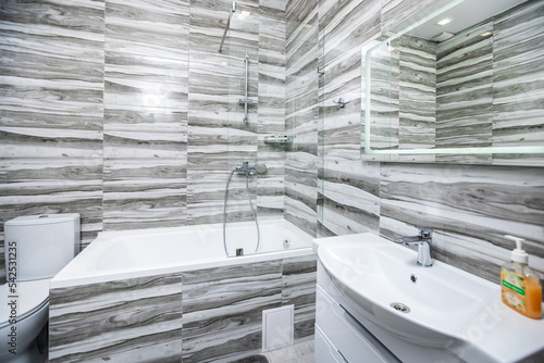 modern bathroom finished with marble tiles in white and gray colors