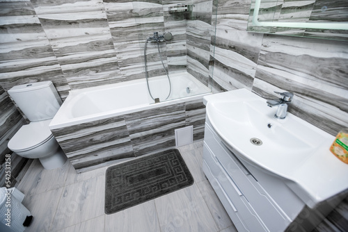 modern bathroom finished with marble tiles in white and gray colors