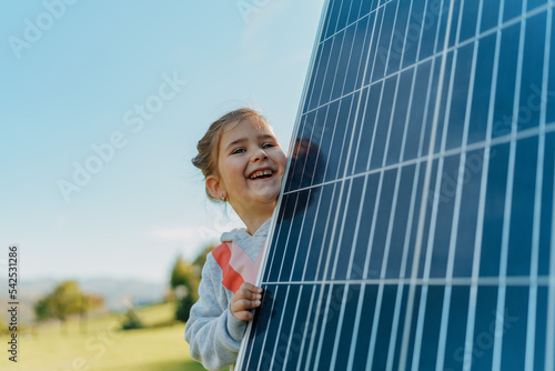 Bild auf Leinwand Little girl holding photovoltaics solar panel