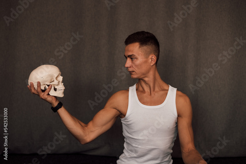 A white skull in the hands of a man. Anatomy photo