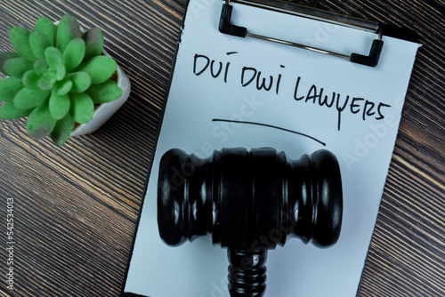 Fotografie Concept of Dui Dwi Lawyers write on paperwork with gavel isolated on Wooden Table