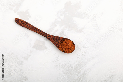 Aguaje powder in wooden spoon. Dried and pulverized pulp of aguaje provides great nutritional value and medicinal benefits, particularly for women's health issues related to hormonal imbalances photo