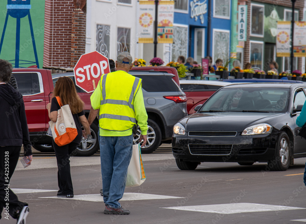 Naklejka premium crossing guard with stop sigh in the street