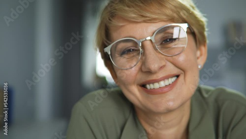 Happy adult woman in eyeglasses posing at camera with healthy toothy smile and fresh breath, oral cavity care, dental prosthetics and aesthetic beauty clinic, close-up