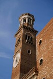 Vertical shot of Torre dei Lamberti with a blue sky background in Italy