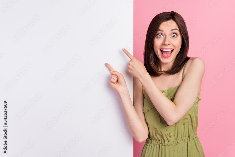 Photo of astonished lady arm demonstrate present empty space wall billboard unexpected reaction isolated on pink color background Photo of astonished lady arm demonstrate present empty space wall billboard unexpected reaction isolated on pink color background