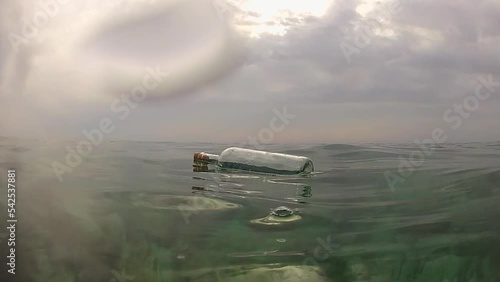 Message in a bottle. A message in a bottle floats on the surface of the sea. Bottle with message at sea