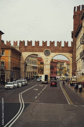 Vertical shot of cars driving throung the archways with a cloudy sky background Fototapeta