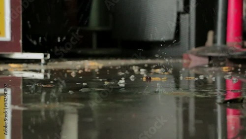 Water is dripping from ceiling to the floor. Water leaking from the ceiling in the warehouse