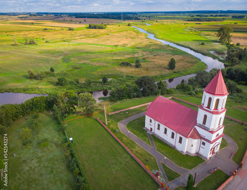 Suraz, Poland - August 8, 2021:  Church of Corpus Christi in Suraż seen from the air photo