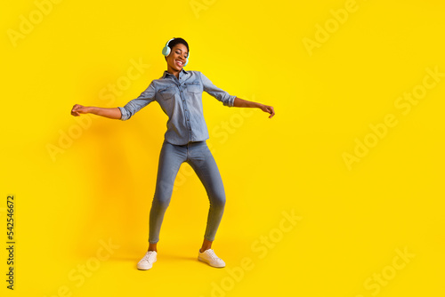 Full length portrait of cheerful satisfied person enjoy free time chilling isolated on yellow color background