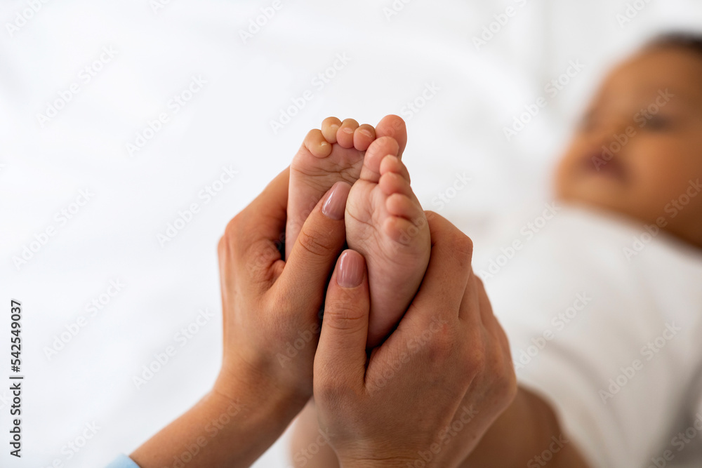Baby Reflexology. Mother Massaging Tiny Feet Of Her Black Infant Child Baby Reflexology. Mother Massaging Tiny Feet Of Her Black Infant Child