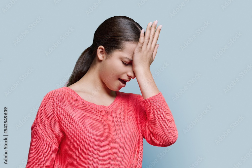 Confused female holding hand on forehead, distressed grimace on face Confused female holding hand on forehead, distressed grimace on face