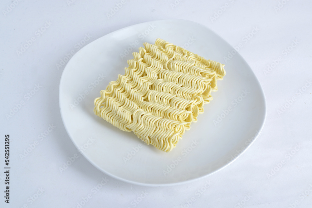 raw instant noodles on white plate, isolated white background raw instant noodles on white plate, isolated white background