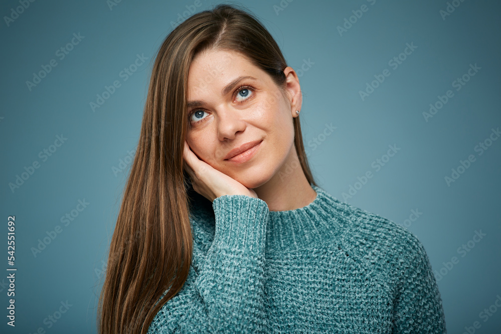 Fototapeta premium Smiling woman touching face and looking up. Isolated female face close up portrait