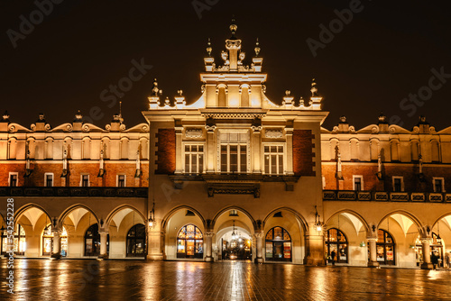 Illuminated Krakow Cloth Hall, Polish Sukiennice on main market square,Poland.Renaissance building at night during Christas.Evening city lights.Festive atmosphere.Historic center of Krakow.UNESCO site