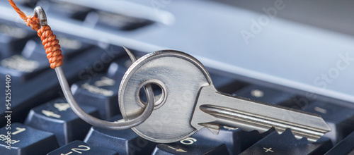 Photos phishing, hacking personal data and money , key and hook on computer keyboard