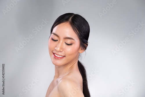Portrait Face shot Beautiful young Asian woman with fashion cosmetic make up clean skin on gray background isolated. Face care, elegance Cosmetology, beauty love female © Jade