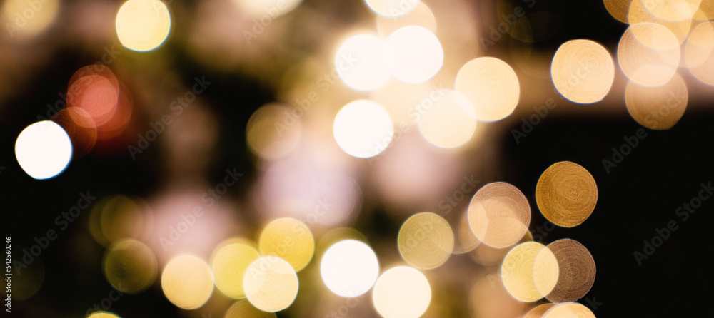 Defocused bokeh lights. Abstract twinkled lights background with bokeh defocused white lights. Valentines Day, Party, Christmas background.