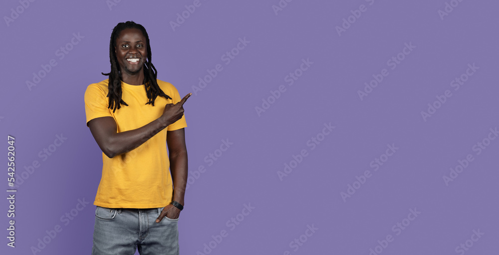 Smiling african american young man pointing at copy space, panorama Smiling african american young man pointing at copy space, panorama