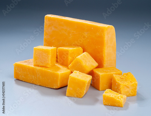 Red Cheddar block and cubes on gradient background