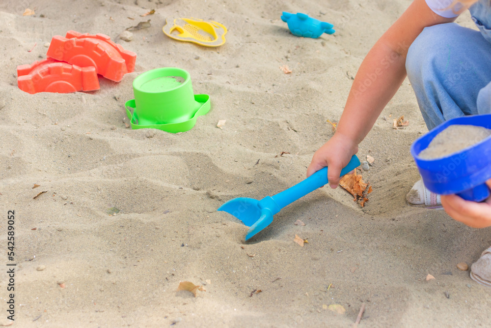 little girl having fun on playground in sandpit. Toddler playing with sand molds and making mudpies. Outdoor creative activities for kids little girl having fun on playground in sandpit. Toddler playing with sand molds and making mudpies. Outdoor creative activities for kids