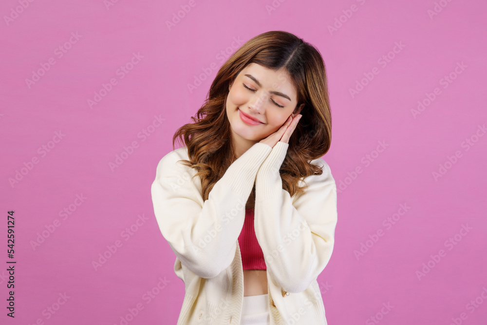 Portrait of smiling young happy woman sleeping with eyes closed while standing isolated over pink background Portrait of smiling young happy woman sleeping with eyes closed while standing isolated over pink background
