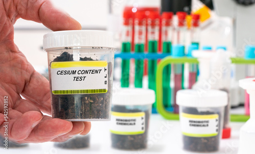 Cesium. Cesium content in soil sample in plastic container. Study of agricultural soil in a chemical laboratory photo
