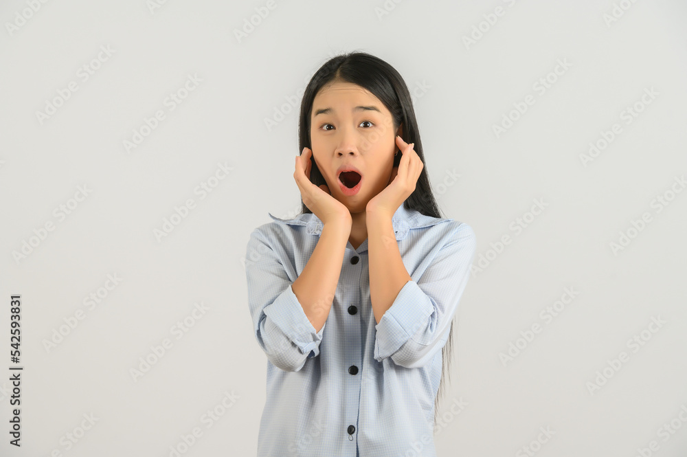 Portrait of Excited young asian woman in blue shirt looking at camera isolated on white background Portrait of Excited young asian woman in blue shirt looking at camera isolated on white background