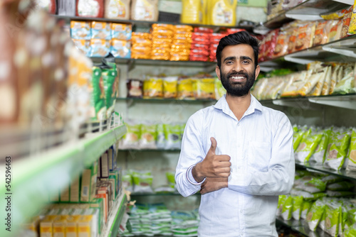 Indian shop keeper in Grocery store showing thumbs up