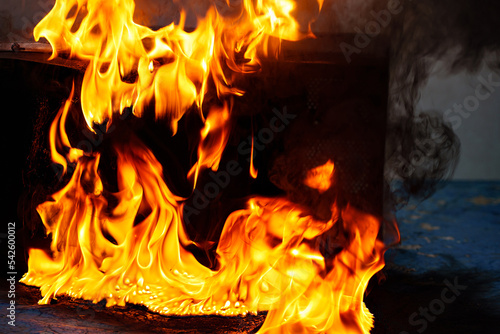 fire and molten plastic on a black background. the concept of fire in the kitchen and malfunctions, breakdowns of electrical appliances and wiring, installation of fire safety systems.