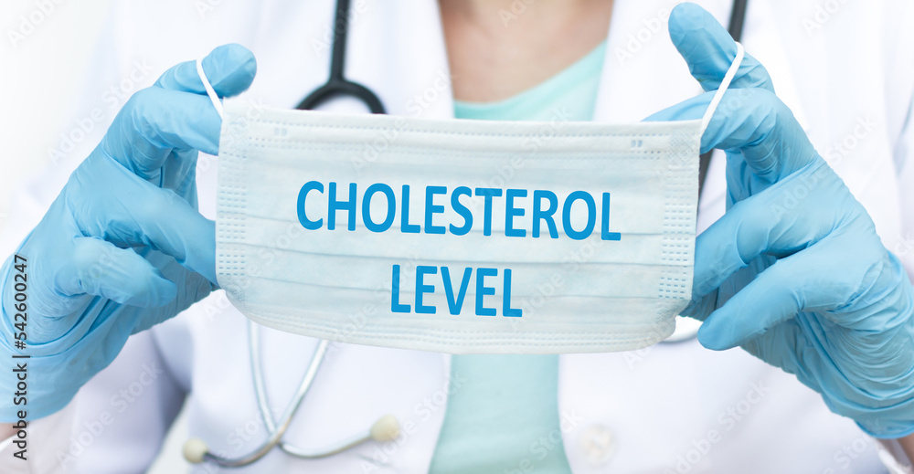 Text Cholesterol LEVELS on mask in doctor's hand with stethoscope, medical concept. Text Cholesterol LEVELS on mask in doctor's hand with stethoscope, medical concept.