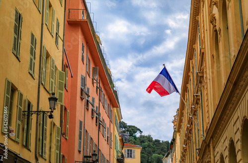 Colorful houses and the French Republic flag in Old Town Nice, South of France