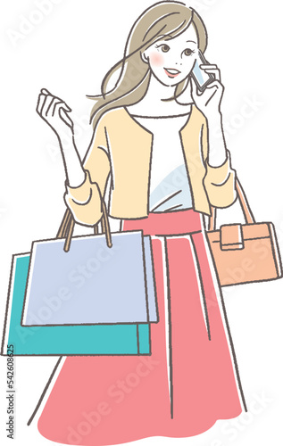 携帯で話すショッピング中の女性