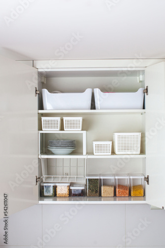 House decor ideas. Storage in the kitchen. Home organization. White shelf and modern interior. photo