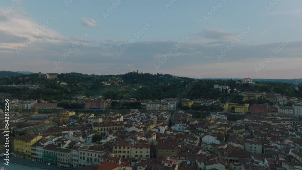 Forwards fly above historic buildings in old town at twilight. Revealing Arno river flowing through city. Florence, Italy Forwards fly above historic buildings in old town at twilight. Revealing Arno river flowing through city. Florence, Italy
