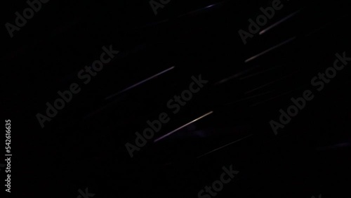 Blur.Night. Snowfall. The light beam of a hand-held flashlight illuminates the falling snowflakes, which become multi-colored when illuminated. The speed of movement of the snowflakes.