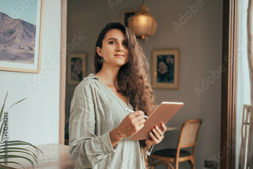 Young girl works on the tablet on the internet and goes to the train, ipad surfing, woman using smartphone, holding tablet in hand, send answer texts, travel in train, office manager, hipster
