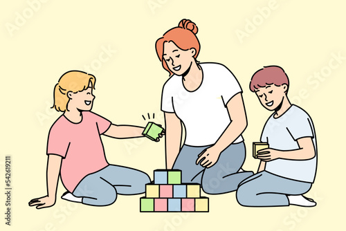 Caring young mother play with children at home. Loving mom engaged in game with colorful blocks with kids on leisure weekend. Vector illustration.  photo