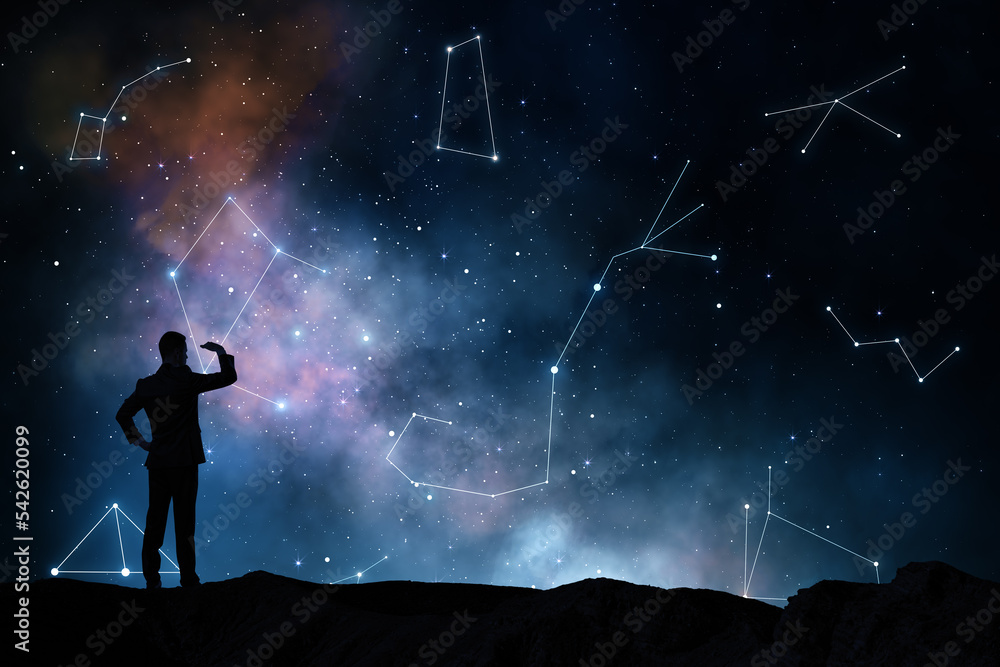 Stars will prompt and horoscope concept with black man silhouette on the earth looking into the distance on starry dark sky with constellations from white lines