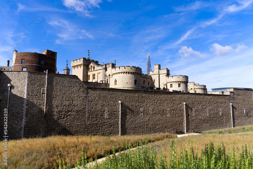 Famous castle Tower of London at City of London on a blue cloudy summer day. Photo taken August 4th, 2022, London, England.