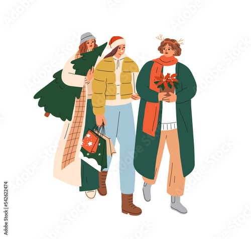 Happy girls going shopping for Christmas. Young women friends preparing gifts...