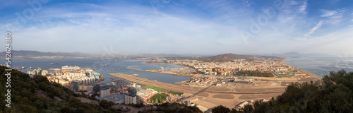 View of the City, Airport and Port from top of Rock of Gibraltar. Sunny Morning Sky. Gibraltar, United Kingdom. Panorama