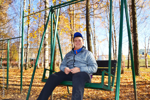 An autistic guy has fun riding a swing